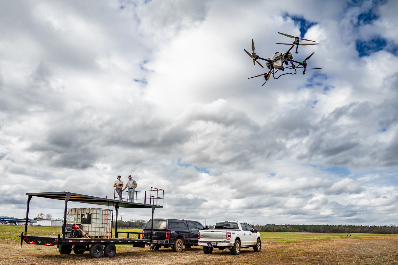 Wide view of the Elevated Ag trailer rig with the drone climbing overhead